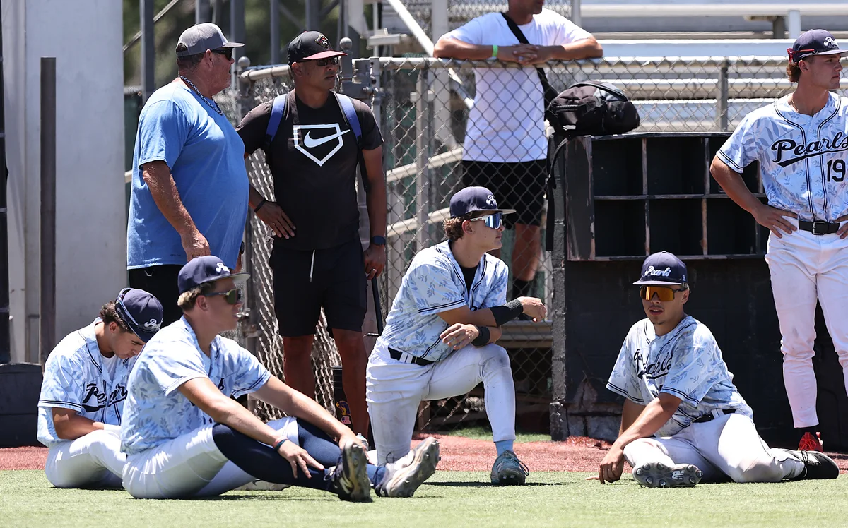 Collegiate players with their coach beside the dugout at the 2026 BACL All-Star game